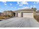 Single-story house with a three-car garage and well-manicured landscaping at 3493 Lupine Bush Ct, Las Vegas, NV 89135