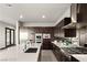 Modern kitchen with island, stainless steel appliances, and dark wood cabinetry at 36 Rainbow Point Pl, Henderson, NV 89011