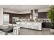 Open kitchen features a large island with seating and white cabinetry at 36 Rainbow Point Pl, Henderson, NV 89011