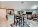 Open concept kitchen with gray cabinets, kitchen island, and views into living room at 377 Yellow Finch Ln, Henderson, NV 89012