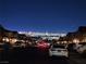 Night view of a residential street with city lights in the background at 377 Yellow Finch Ln, Henderson, NV 89012