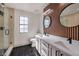 Modern bathroom with double vanity, walk-in shower, and stylish wood wall accents at 5213 Tamanar Dr, Las Vegas, NV 89130