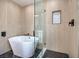 Spa-like bathroom featuring a freestanding bathtub and a glass-enclosed shower at 5213 Tamanar Dr, Las Vegas, NV 89130