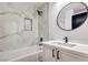 Clean bathroom with marble tile, a bathtub, and a vanity at 5213 Tamanar Dr, Las Vegas, NV 89130