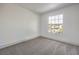 Bright bedroom with grey carpet and a large window at 5213 Tamanar Dr, Las Vegas, NV 89130