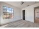 Bright bedroom with grey carpet, large window and a door at 5213 Tamanar Dr, Las Vegas, NV 89130