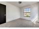 Bright bedroom featuring a large window and plush carpeting at 5213 Tamanar Dr, Las Vegas, NV 89130