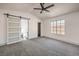 Spacious bedroom with vaulted ceilings, ceiling fan, and barn door at 5213 Tamanar Dr, Las Vegas, NV 89130