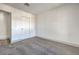 Bright bedroom with grey carpet and double doors to closet at 5213 Tamanar Dr, Las Vegas, NV 89130