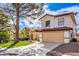 Two-story house with a tan facade, red roof, and a landscaped front yard at 5213 Tamanar Dr, Las Vegas, NV 89130