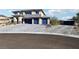 Two-story house with blue garage doors and a paver driveway at 5448 Hestia Hills Ct, Las Vegas, NV 89149