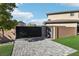 Modern double gate leading to a paved driveway and garage at 5448 Hestia Hills Ct, Las Vegas, NV 89149