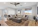 Living room with large sectional sofa and wood-look floors at 5448 Hestia Hills Ct, Las Vegas, NV 89149