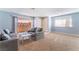 Living area with gray couches, glass-top table, and sliding door at 6552 Figtree Rd, Las Vegas, NV 89108