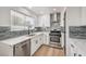 Updated kitchen, featuring white cabinets and gray tile backsplash at 6804 Atrium Ave, Las Vegas, NV 89108