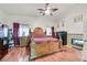 Main bedroom with fireplace and large, ornate wooden bed at 791 Maranello St, Henderson, NV 89052