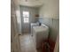 Convenient laundry room with washer, dryer, and overhead shelving at 8230 Grizzly Peak Dr, Las Vegas, NV 89113