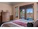 Main bedroom with pool view, king-size bed, and large windows at 888 Ironwood Dr, Mesquite, NV 89027