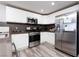 Modern kitchen with stainless steel appliances and white cabinetry at 912 Duckhorn Ct # 101, Las Vegas, NV 89144