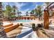 Community pool with lounge chairs and shade structures at 912 Duckhorn Ct # 101, Las Vegas, NV 89144