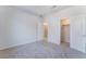 Neutral bedroom featuring carpeted floors, a walk-in closet, and a simple interior door at 9333 Observatory St, Las Vegas, NV 89143