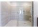 Close-up of the tiled glass enclosed shower with bench seating at 9333 Observatory St, Las Vegas, NV 89143