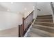 Carpeted staircase with dark wood banister and railing leading to upper level at 9333 Observatory St, Las Vegas, NV 89143