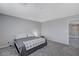 Bright bedroom featuring a king-size bed and access to a hallway at 10122 Ashford Mill Ct, Las Vegas, NV 89178