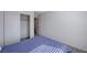 Upstairs bedroom with blue bedding and closet at 10122 Ashford Mill Ct, Las Vegas, NV 89178
