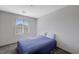 Upstairs bedroom with blue bedding and window at 10122 Ashford Mill Ct, Las Vegas, NV 89178