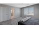 Well-lit bedroom with carpet and en-suite bathroom at 10122 Ashford Mill Ct, Las Vegas, NV 89178