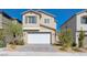 Two-story house with white garage door and landscaping at 10122 Ashford Mill Ct, Las Vegas, NV 89178