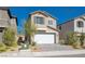 Two-story house with white garage door and landscaping at 10122 Ashford Mill Ct, Las Vegas, NV 89178