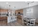 Modern kitchen with island, light wood cabinets, and granite countertops at 10122 Ashford Mill Ct, Las Vegas, NV 89178