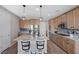 Modern kitchen with light wood cabinets and granite countertops at 10122 Ashford Mill Ct, Las Vegas, NV 89178