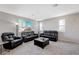 Spacious living area featuring neutral carpeting and comfortable seating at 10122 Ashford Mill Ct, Las Vegas, NV 89178