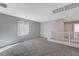 Open loft area with gray carpet and window at 10122 Ashford Mill Ct, Las Vegas, NV 89178