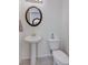 Clean powder room with pedestal sink and toilet at 10122 Ashford Mill Ct, Las Vegas, NV 89178
