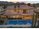 Luxury home with a sparkling pool, landscaped backyard, and a sprawling tile roof at 10923 Willow Heights Dr, Las Vegas, NV 89135