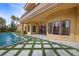 Inviting backyard with a sparkling pool, manicured lawn, and seamless flow to the home's outdoor living spaces at 10923 Willow Heights Dr, Las Vegas, NV 89135
