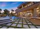 Expansive backyard showcasing a luxurious pool, meticulously designed patio, and outdoor cooking area, ideal for entertaining guests at 10923 Willow Heights Dr, Las Vegas, NV 89135