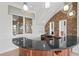 Charming bar featuring a stone wall, granite countertop and custom lighting, perfect for entertaining guests at 10923 Willow Heights Dr, Las Vegas, NV 89135