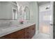 Elegant bathroom with dual sinks, marble backsplash, and a view to the bedroom at 10923 Willow Heights Dr, Las Vegas, NV 89135