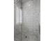 Luxurious bathroom featuring a glass shower with marble tile, rainfall showerhead, and geometric-patterned flooring at 10923 Willow Heights Dr, Las Vegas, NV 89135