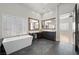 Modern bathroom with a soaking tub, dual sinks, and large mirrors for a bright and open feel at 10923 Willow Heights Dr, Las Vegas, NV 89135