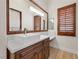 Elegant bathroom with a square sink, wood cabinets, and quartz countertops, creating a serene space at 10923 Willow Heights Dr, Las Vegas, NV 89135