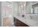 Elegant bathroom featuring dual sinks, marble backsplash and stylish fixtures at 10923 Willow Heights Dr, Las Vegas, NV 89135