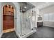 Luxury bathroom featuring a glass-enclosed shower, dual shower heads, and custom wooden cabinets at 10923 Willow Heights Dr, Las Vegas, NV 89135