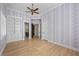 Elegant bedroom with decorative wall paper, light hardwood floors, and custom built in shelving at 10923 Willow Heights Dr, Las Vegas, NV 89135