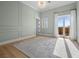 Bright bedroom with a large area rug, recessed panel walls, and a balcony at 10923 Willow Heights Dr, Las Vegas, NV 89135